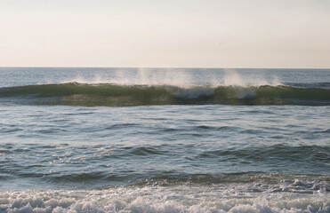 crashing wave in morning light 