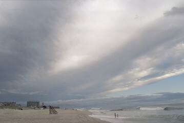 evening clouds with beach, lifeguard stand, and surf 