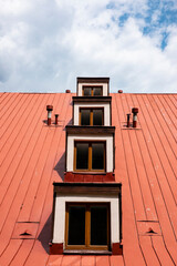 A cascade of windows on a tin roof