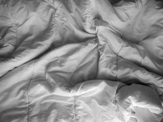 White wrinkled, crumpled light fabric on the bed. the texture of the fabric. Layout for the poster