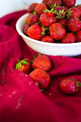 Red ripe strawberries on a red background