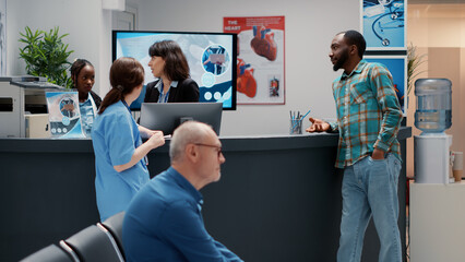 Multiethnic people chatting about medical system support, african american patient and hospital...