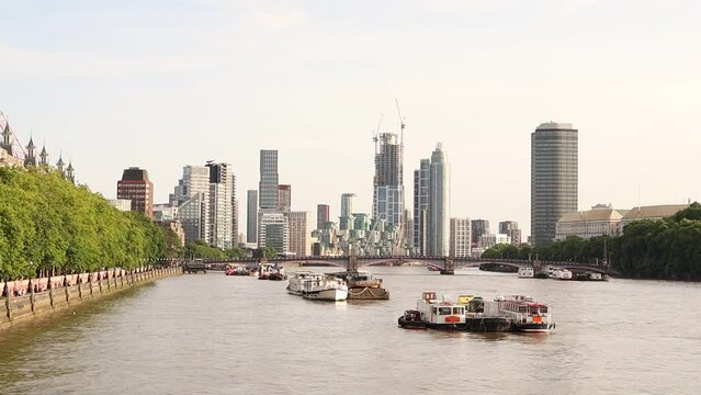 Beautiful view of the London Vauxhall skyscrapers near the River Thames with boats on it