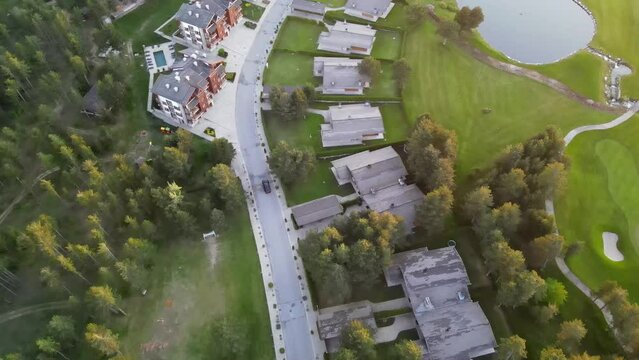 Aerial shot of the Piring Golf playground in Razlog Bulgaria with cars passing on the road