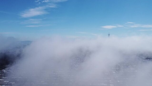Drone view of San Francisco's Sunset District with views of Downtown and Sutro Tower through fog