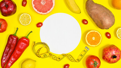 Creative copy space on yellow background with red fruits and vegetables. Flat lay diet and healthy concept.