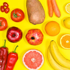 Yellow brackground with summer fruits and vegetables in colors from red to yellow. Flat lay pattern