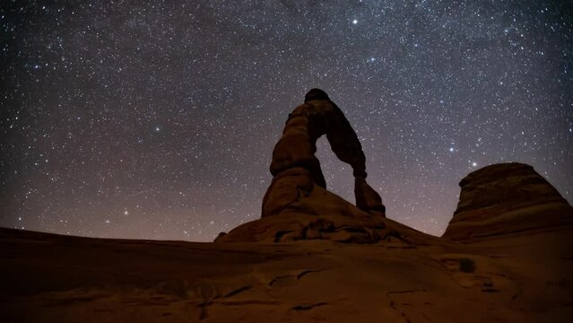 Time-lapse footage of the stone arch in Moab city under the starry night sky