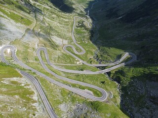 Aerial view of lovely switchback roads in a green mountainous area