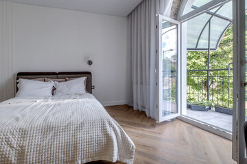 interior of expensive bedroom in studio apartments with arched access to the balcony