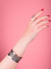 Closeup female hand with a ring and bracelet  on your wrist. Handmade jewelry and accessories....