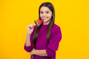 Teen girl hold lollipop caramel on yellow background, candy shop. Teenager with sweets suckers.