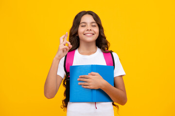 School girl teenager child with book and copybook. Teenager schoolgirl student with backpack, isolated background. Learning and knowledge education concept.