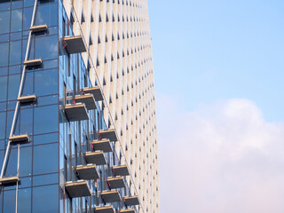Part of a high-rise building under construction. End of construction. Finished works. Facade of a new beautiful skyscraper. Modern engineering.
