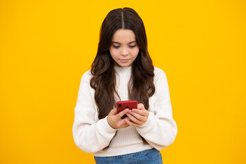Child girl 12, 13, 14 years old with smart phone. Hipster teen girl types text message on cellphone, enjoys mobile app. Kid hold smartphone texting in online social media. Internet addiction.