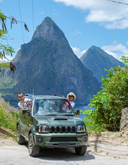 a couple of men and women exploring the Island of St Lucia in a rental car. Mountains of Saint...