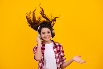 Amazed teenager. Stylish teenage girl listening to music with headphones. Kids lifestyle concept. Wireless earphones. Excited teen girl.