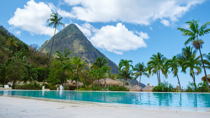 Sugar beach Saint Lucia, is a public white tropical beach with palm trees and luxury beach chairs...