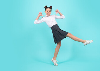 Amazed teenager. Happiness, freedom, motion and child. Young teenager girl wear summer dress jumping in air over blue background. Excited teen girl.