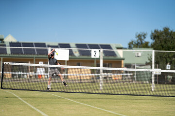 
Amateur playing tennis at a tournament and match on grass in Melbourne, Australia 
