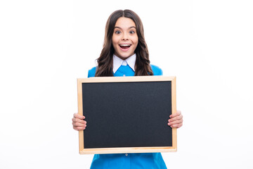 Naklejka premium Teenager younf school girl holding school empty blackboard isolated on white background. Portrait of a teen female student.