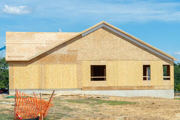 a residential duplex house construction project showing the plywood roof and oriented strand board...