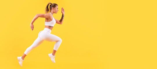 Fototapeta na wymiar fitness woman runner running on yellow background. Woman jumping running banner with mock up copyspace.