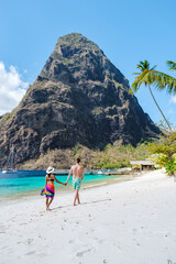 couple walking on the beach during summer vacation on a sunny day, men and woman on vacation at the...