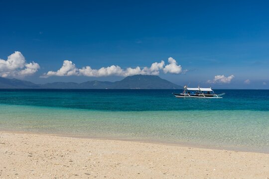 Boat on the water by the Bon Bon beach in Romblon, Philippines