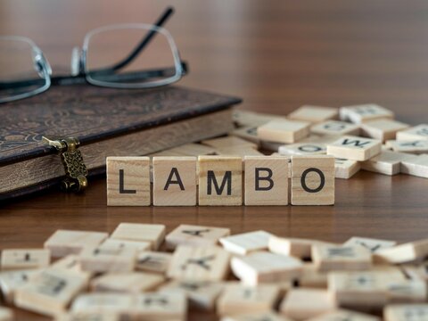 lambo word or concept represented by wooden letter tiles on a wooden table with glasses and a book