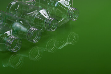 Beautiful shot of plastic bottles with reflection isolated on light green background
