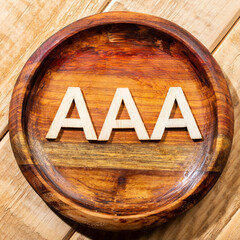 Triple A letters, in wooden bowl on the table