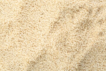 Pile of white sesame seeds as background, top view