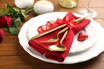 Beautiful table setting for Valentine's Day dinner on wooden background, closeup