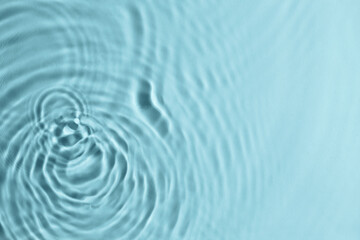 Fototapeta premium Closeup view of water with circles on turquoise background. Space for text