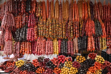 Bunches of different delicious churchkhelas at market
