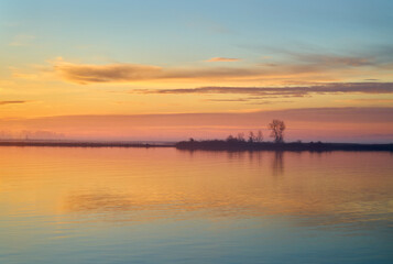 Calm Fraser River Sunrise. Quiet, early morning sunrise clouds on the Fraser River, British Columbia. 

