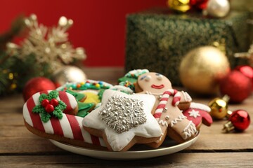Sweet Christmas cookies and festive decor on wooden table