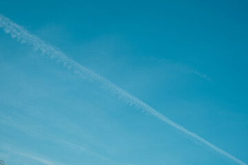 Traces of the jet engine of the plane in the summer sky