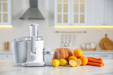 Modern juicer, fresh vegetables and fruits on table in kitchen