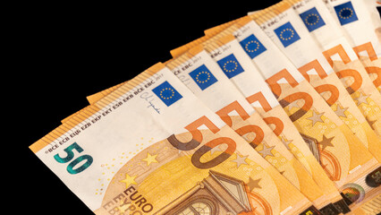 Banknotes of fifty euros, on a black background