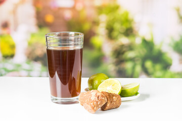 cubes Panela and agua de panela and lemon or candies made from sugar cane and lemon in nature, typical food of Colombia
