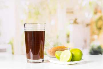granulated panela, agua de panela and lemon or sugar cane sweets and lemon in the kitchen, typical food of Colombia