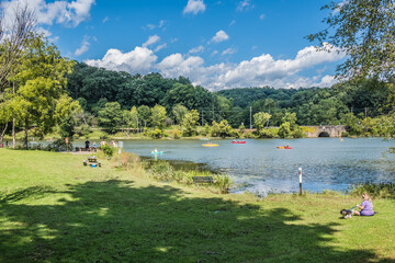 Great day to be in the park to enjoy kayaking and fishing as well as other outdoor activities. It is a nice weather and the sun is out in North Park, Pittsburgh, Pennsylvania, USA. - obrazy, fototapety, plakaty