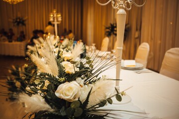 Close-up shot of a wedding table decorated with white ros