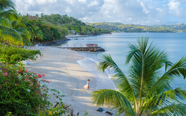 Asian women walking at the beach on vacation in Saint Lucia, luxury holiday Saint Lucia Caribbean,...