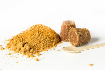 front view of granulated and cubes panela on white background with copy space