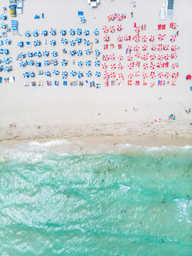 Drone aerial view at Miami South Beach Florida. Beach with colorful chairs and umbrellas, top view of the beach Miami Florida
