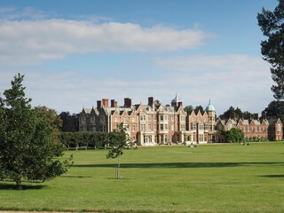 Beautiful Sandringham Estate in England surrounded by green grass and lush trees
