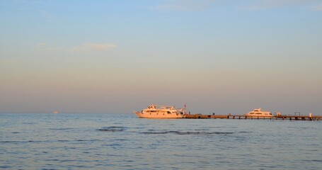 Fototapeta premium at sunset ships at sea. High quality photo